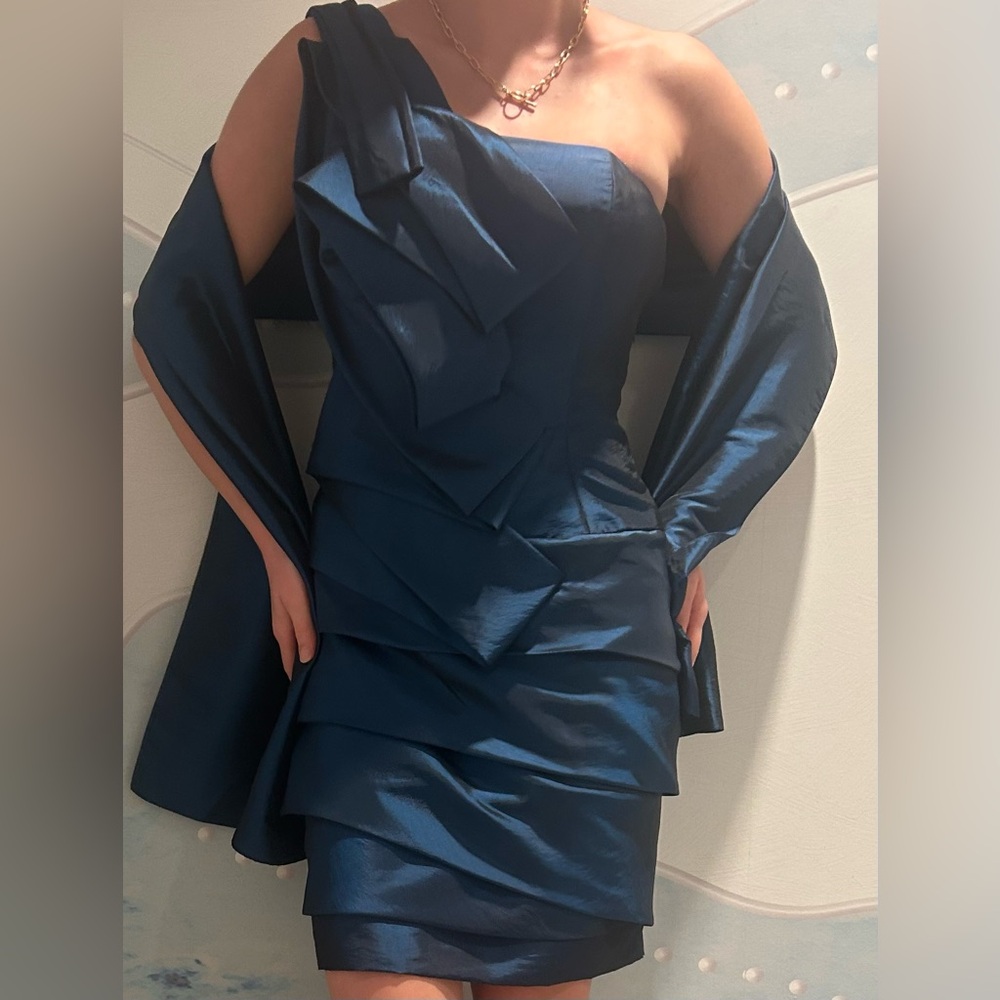 A stunning form fitting dress with an elegant neckline + sultry bold silhouette